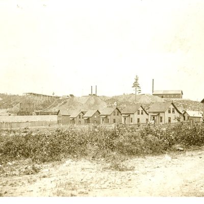 The building at the right of this photo is the original Oliver Club of the Oliver Mining Company. This photo captures the lower end of Jasper Street in Soudan, circa 1910.  From the left, these homes were inhabited in those early days by the Tezak family, Edwin St. Vincent family, Jack Hill family, Mr. and Mrs. Ernest Carlson, Harold Carlson family, and Conrad Lindstrom family. The Oliver Club was later converted into a residence where the Sulo Peitso family lived.